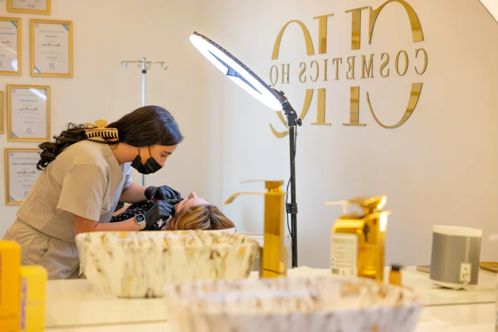 An aesthetic practitioner injecting a clients face with an anti wrinkle treatment - shown further away