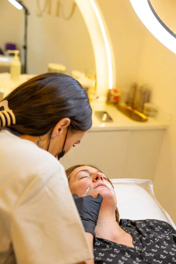 An aesthetic practitioner injecting a clients face with an anti wrinkle treatment