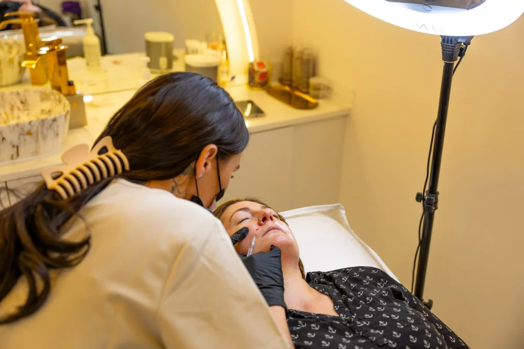An aesthetic practitioner injecting a clients face with an anti wrinkle treatment